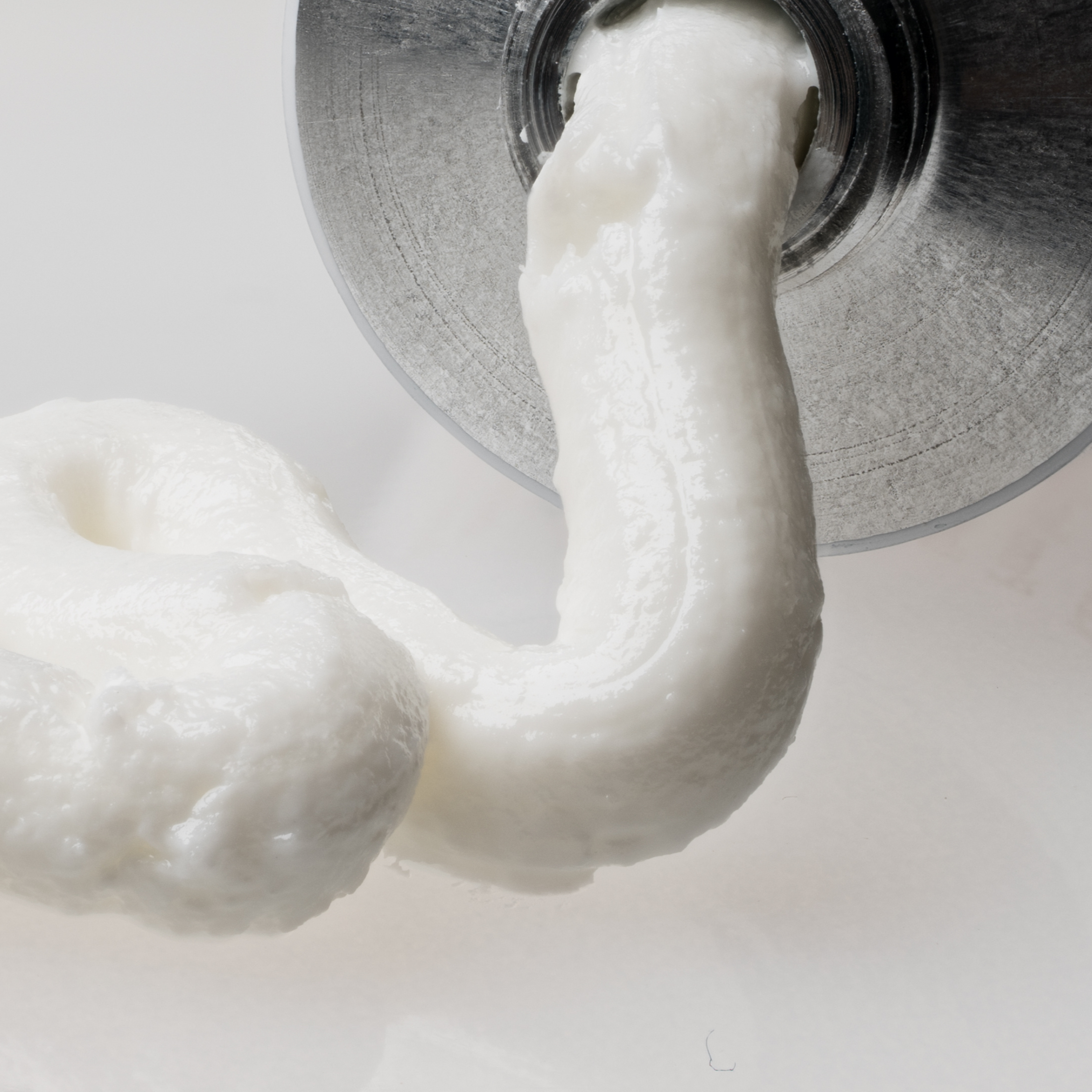A closeup of Everist waterless hair concentrate being squeezed out of the tube. Mobile Image.