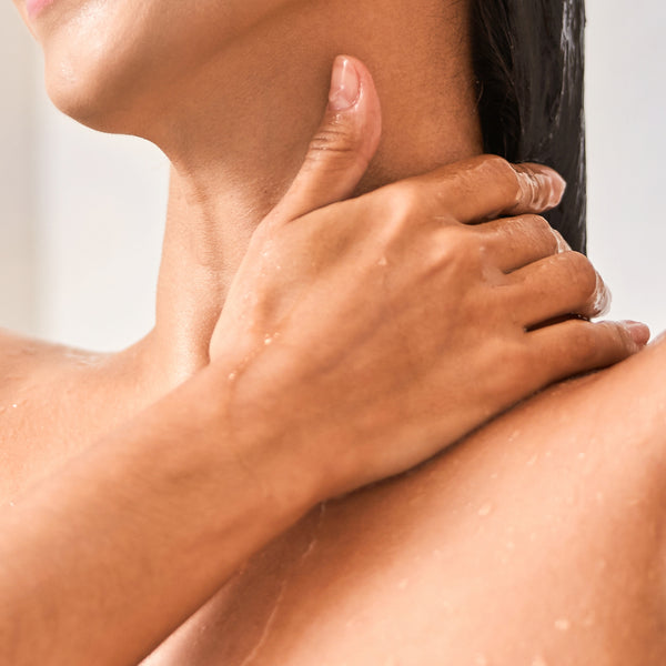 In the shower, wet hands and body. 