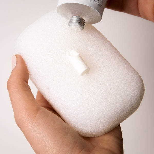 Slide tube key over top of tube and roll down gently to dispense a 1-inch strip of the concentrate paste onto palm or our konjac sponge.